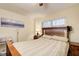 Cozy bedroom with a wooden bed frame, soft bedding, a bedside table with a lamp, and a bright window at 652 Trailwood Sw Ln, Marietta, GA 30064