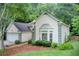 Charming single-Gathering home with a two-car garage, lush landscaping, and a welcoming, light colored exterior at 652 Trailwood Sw Ln, Marietta, GA 30064