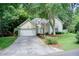 Inviting front view of a single-Gathering home featuring a two-car garage, lawn, and well-maintained landscaping at 652 Trailwood Sw Ln, Marietta, GA 30064