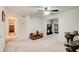 Spacious living room featuring neutral-toned walls, plush carpeting, and a ceiling fan for added comfort at 652 Trailwood Sw Ln, Marietta, GA 30064