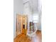Hallway with a modern chair, hardwood floors, a bathroom, and a window with natural light at 1661 La France Stret Ne, Unit #216, Atlanta, GA 30307