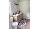 Bathroom with a new vanity, decorative mirror, and a toilet, accented by a stylish rug at 6402 Kensington Ct, Austell, GA 30106