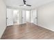 Spacious bedroom with three open doors and wood-look flooring at 6402 Kensington Ct, Austell, GA 30106
