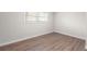 Empty bedroom featuring wood-look floors and a window at 6402 Kensington Ct, Austell, GA 30106