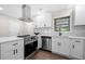 New kitchen featuring stainless steel appliances, a range hood, and white cabinets at 6402 Kensington Ct, Austell, GA 30106