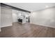 Spacious open-concept living area featuring wood floors and opening into a modern kitchen at 6402 Kensington Ct, Austell, GA 30106