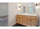 Bathroom with a double sink vanity, black tile flooring, and modern fixtures offers a stylish and functional space at 8398 Members Dr, Jonesboro, GA 30236