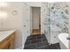 Elegant bathroom featuring a marble shower, sleek vanity, and dark tile flooring, creating a spa-like ambiance at 8398 Members Dr, Jonesboro, GA 30236
