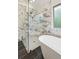 Modern bathroom featuring a seamless glass shower with marble accents and tiled floors, creating a serene retreat at 8398 Members Dr, Jonesboro, GA 30236
