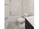 Bathroom featuring a shower-tub combo and geometric-patterned tile floor at 8398 Members Dr, Jonesboro, GA 30236