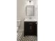 Bathroom featuring a vanity with black wood cabinets and a square mirror and geometric floors at 8398 Members Dr, Jonesboro, GA 30236