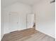 Spacious bedroom with vaulted ceilings, light hardwood floors, and white doors, offering modern comfort at 8398 Members Dr, Jonesboro, GA 30236