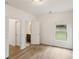 Bedroom view showcasing an ensuite bathroom, with hardwood floors and ample light at 8398 Members Dr, Jonesboro, GA 30236