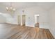Bonus room with wood flooring, neutral walls, a chandelier, and adjacent access to a full bathroom at 8398 Members Dr, Jonesboro, GA 30236