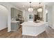 Bright kitchen with light grey cabinets, white quartz countertops, stainless appliances, and modern lighting at 8398 Members Dr, Jonesboro, GA 30236