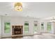 Bright living room featuring a stone fireplace, hardwood floors, and plenty of natural light at 8398 Members Dr, Jonesboro, GA 30236