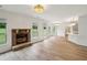 Bright open living room with a stone fireplace and view to the backyard at 8398 Members Dr, Jonesboro, GA 30236