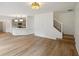Bright living room view with modern light fixture, hardwood floors, and open access to kitchen at 8398 Members Dr, Jonesboro, GA 30236
