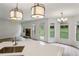 Bright open-concept living room with kitchen, fireplace, modern lighting, and backyard view at 8398 Members Dr, Jonesboro, GA 30236