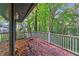 A covered back deck surrounded by dense trees gives a natural view at 1352 Overlook Se Cv, Smyrna, GA 30080