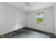 Empty bedroom featuring window with treed exterior view and ceiling fan at 1352 Overlook Se Cv, Smyrna, GA 30080