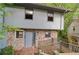 Split level home with stone facade and wooden deck leading to the front door at 1352 Overlook Se Cv, Smyrna, GA 30080