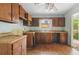 Kitchen with damaged flooring, wood cabinetry, and double sink at 1352 Overlook Se Cv, Smyrna, GA 30080