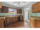 View of kitchen with damaged wood cabinets, laminate countertops and double sink at 1352 Overlook Se Cv, Smyrna, GA 30080