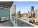 The covered balcony includes lounge seating and skyline views at 3325 Piedmont Rd Ne # 1907, Atlanta, GA 30305