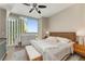 Bedroom features a ceiling fan, a large window with city views, and neutral paint at 3325 Piedmont Rd Ne # 1907, Atlanta, GA 30305
