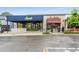 Commercial building exteriors showing Aiva and Piú Bello restaurant storefronts and outdoor seating on a wet day at 3325 Piedmont Rd Ne # 1907, Atlanta, GA 30305