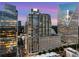 Stunning high-rise condo building with modern architecture and city views at sunset at 3325 Piedmont Rd Ne # 1907, Atlanta, GA 30305