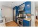 Stylish kitchen with granite countertops, stainless steel appliances, and blue cabinetry at 3325 Piedmont Rd Ne # 1907, Atlanta, GA 30305