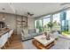 Bright living room features floor to ceiling windows with city views, hardwood floors, and an open concept design at 3325 Piedmont Rd Ne # 1907, Atlanta, GA 30305