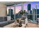 Comfortable living room is filled with natural light and skyline views at 3325 Piedmont Rd Ne # 1907, Atlanta, GA 30305