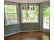 Cozy dining area with hardwood floors and large windows overlooking lush greenery, creating a peaceful atmosphere at 3875 Wintergreen Ct, Marietta, GA 30062