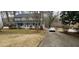 Traditional two-story home with a welcoming front porch, landscaped yard and an adjacent driveway with car at 3875 Wintergreen Ct, Marietta, GA 30062
