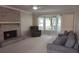 Cozy living room features a brick fireplace, large bay window, and comfortable seating, perfect for relaxation at 3875 Wintergreen Ct, Marietta, GA 30062