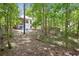 A view of the backyard with a chainlink fence and lush trees at 408 Victoria Place Dr, Locust Grove, GA 30248