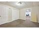 Spacious basement area featuring gray carpet, white walls, and ample storage space at 408 Victoria Place Dr, Locust Grove, GA 30248
