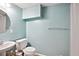 Compact bathroom with a vanity, toilet, and shower with light blue walls at 408 Victoria Place Dr, Locust Grove, GA 30248