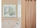Relaxing soaking tub with a window view, set in a neutral-toned bathroom at 408 Victoria Place Dr, Locust Grove, GA 30248