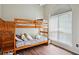 Charming bedroom featuring a bunk bed, wood floors and bright window at 408 Victoria Place Dr, Locust Grove, GA 30248