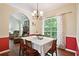 Charming dining room featuring a chandelier and large window views at 408 Victoria Place Dr, Locust Grove, GA 30248