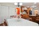 Open-concept dining room showcasing hardwood floors and an adjacent kitchen at 408 Victoria Place Dr, Locust Grove, GA 30248