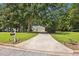 Well maintained property features a long driveway and established landscaping at 408 Victoria Place Dr, Locust Grove, GA 30248