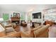 Cozy living room features a brick fireplace and comfortable seating at 408 Victoria Place Dr, Locust Grove, GA 30248