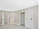 Bright bedroom features a ceiling fan, carpet flooring, and open closet with white trim at 1950 Stethem Fry, Alpharetta, GA 30022