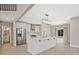 Modern kitchen with stainless steel appliances, a large island, and sleek white cabinetry, adjacent to the dining area at 1950 Stethem Fry, Alpharetta, GA 30022
