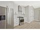 Stylish kitchen featuring stainless steel appliances, subway tile backsplash, and light-colored flooring at 1950 Stethem Fry, Alpharetta, GA 30022